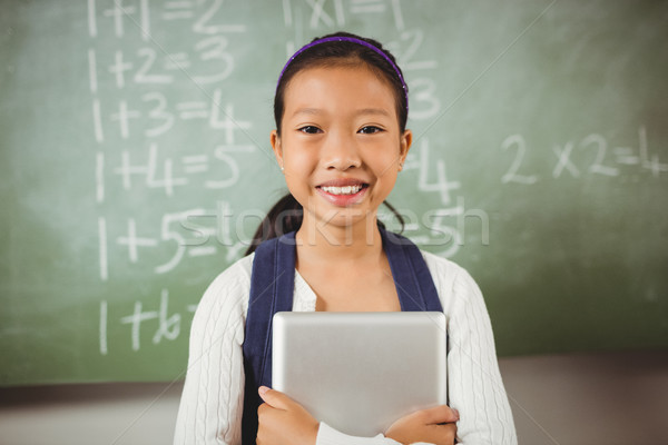 Smiling schoolgirl looking at the camera Stock photo © wavebreak_media