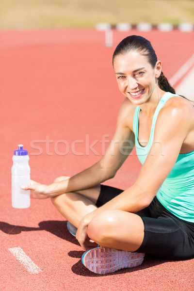 Portré fáradt női atléta ül vizes flakon Stock fotó © wavebreak_media
