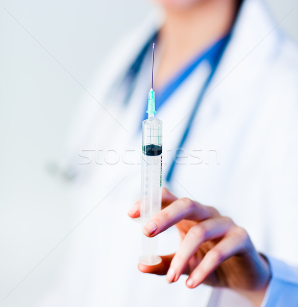 Doctor holding a needle Stock photo © wavebreak_media
