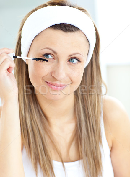 Caucasian woman using mascara in the bathroom at home Stock photo © wavebreak_media