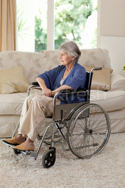 Stock photo: Retired woman in her wheelchair at home