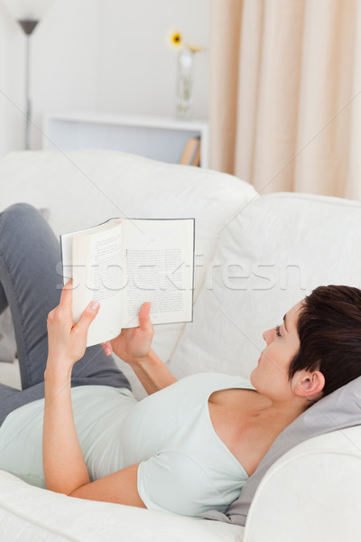 Short-haired woman reading a book in her living room Stock photo © wavebreak_media