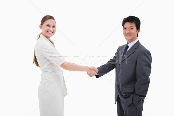 Two business people shaking hands against a white background Stock photo © wavebreak_media