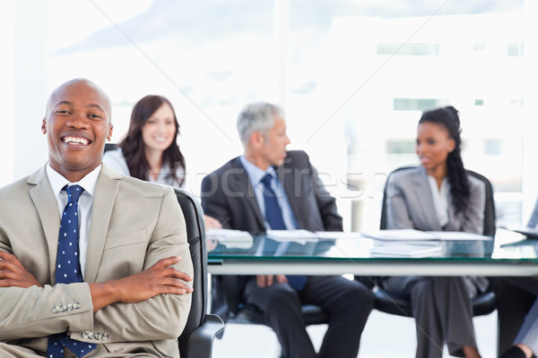 Stock photo: Young executive crossing his arms while laughing and looking at the camera
