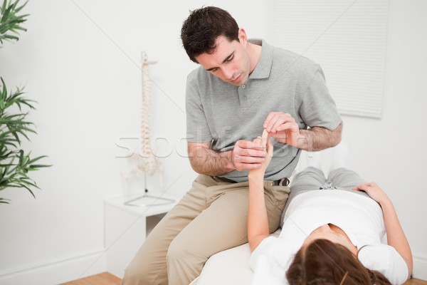 Physiotherapist moving the forefinger of a patient in a room Stock photo © wavebreak_media
