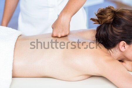 Doctor massaging his patient while using the back of his hand in a room Stock photo © wavebreak_media