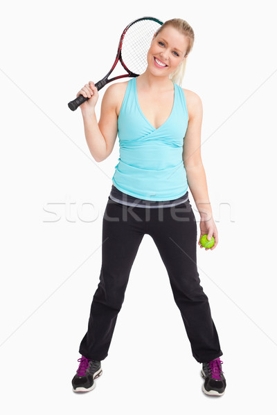 Woman having a ball and tennis racquet againsta white background Stock photo © wavebreak_media