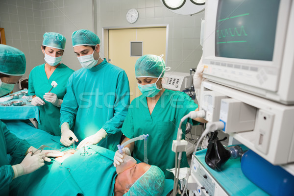 Surgical team next to a monitor in an operating theatre Stock photo © wavebreak_media