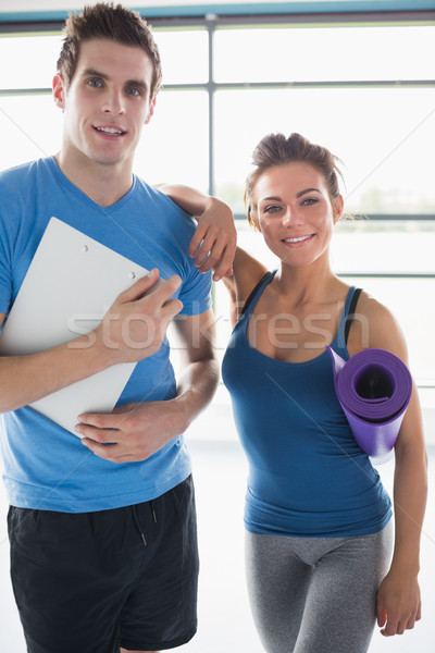 Trainer and smiling woman in gym Stock photo © wavebreak_media