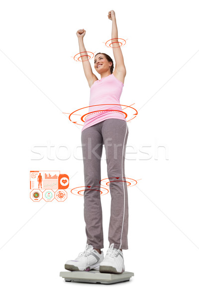 Composite image of young woman cheering on weight scale Stock photo © wavebreak_media