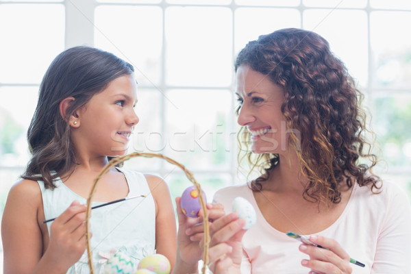 Happy mother and daughter painting easter eggs  Stock photo © wavebreak_media