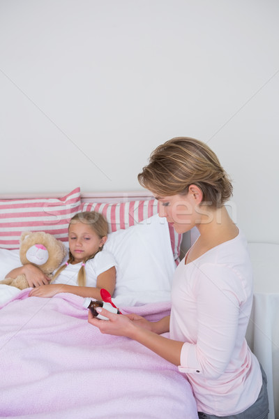 Mother about to give medicine to sick daughter Stock photo © wavebreak_media