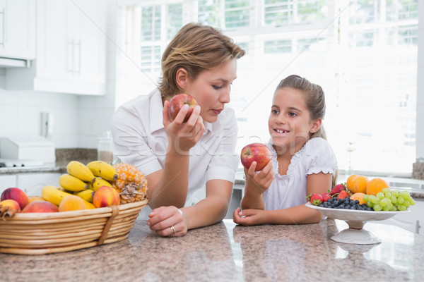 Stock photo: Mother and daughter holding apples