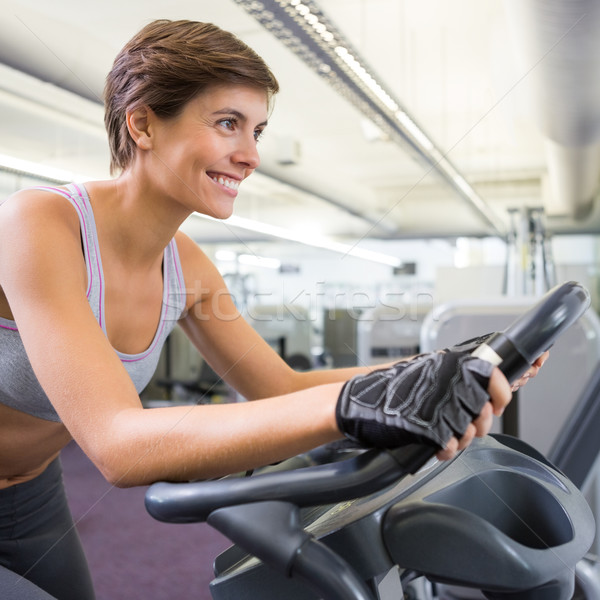 Fit smiling woman working out on the exercise bike Stock photo © wavebreak_media
