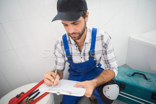 Plumber taking notes on clipboard Stock photo © wavebreak_media