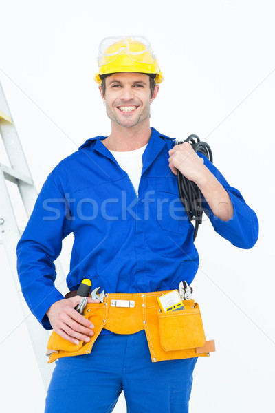 Happy electrician with wires against white background  Stock photo © wavebreak_media