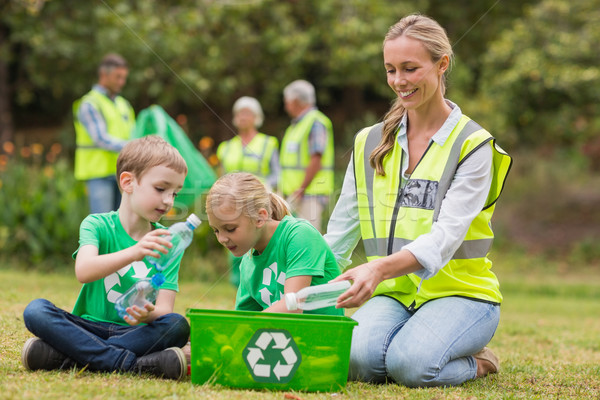 Stock photo: Happy family collecting rubbish 