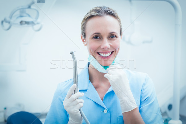 Female dentist holding dental tool Stock photo © wavebreak_media