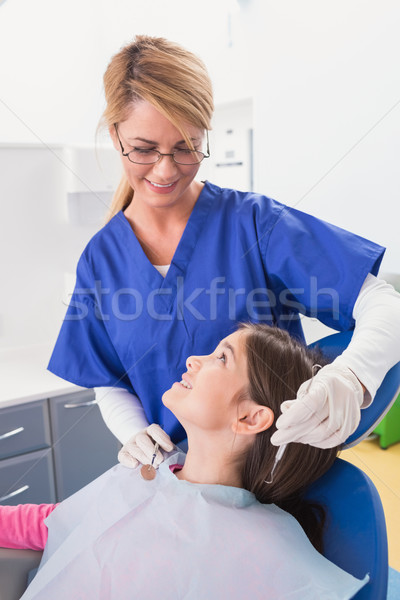 Smiling pediatric dentist with a happy young patient  Stock photo © wavebreak_media