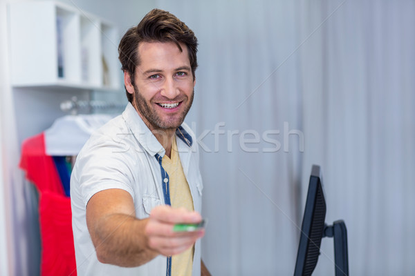 Smiling cashier handing back credit card  Stock photo © wavebreak_media