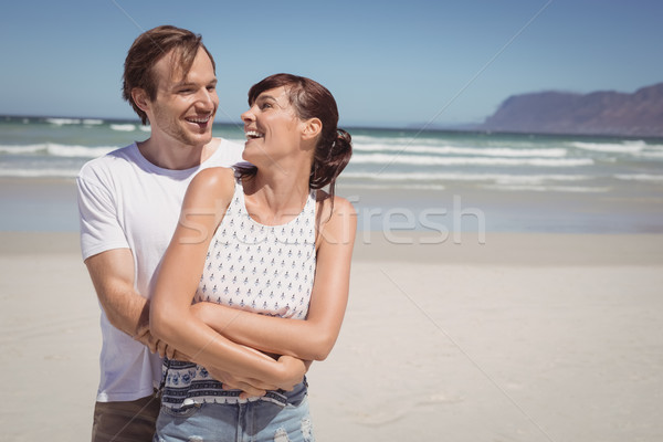 Cheerful couple embracing at beach Stock photo © wavebreak_media