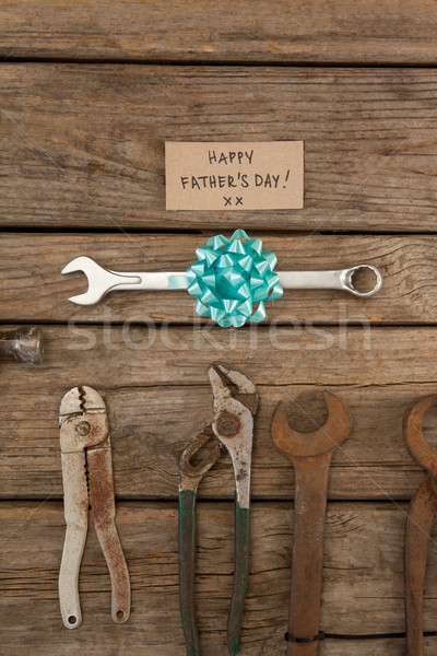 Paper with happy fathers day text and hand tools on table Stock photo © wavebreak_media