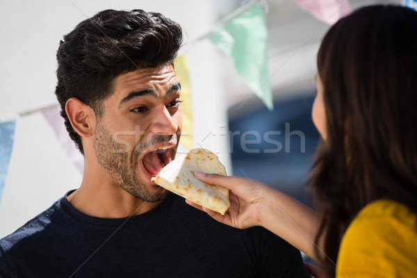 Woman feeding tortilla to friend Stock photo © wavebreak_media