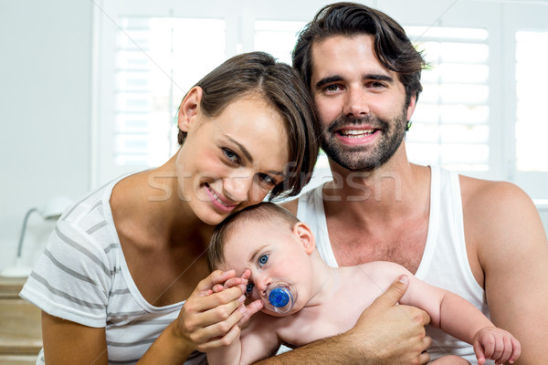 Happy parents with baby boy in bedroom Stock photo © wavebreak_media