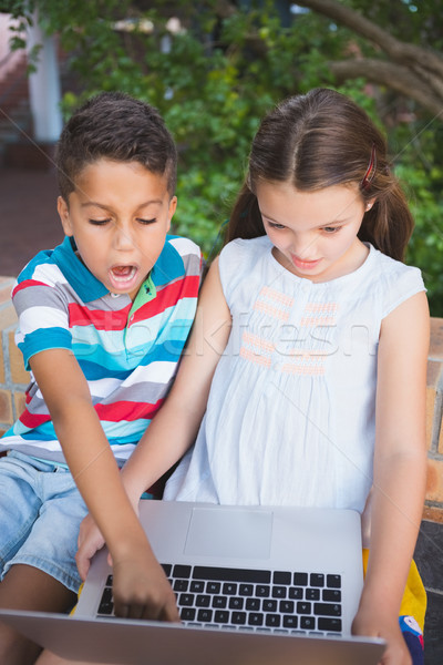 Schoolkids using laptop in school campus Stock photo © wavebreak_media