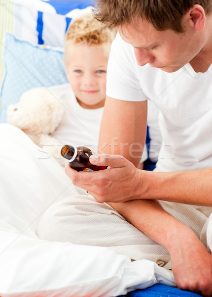 Concerned man looking after his sick son  Stock photo © wavebreak_media