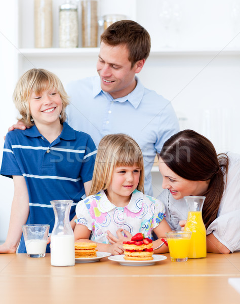 Jolly family eating breakfast in the kitchen Stock photo © wavebreak_media