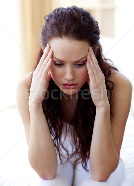 Beautiful girl having a headache in bed Stock photo © wavebreak_media