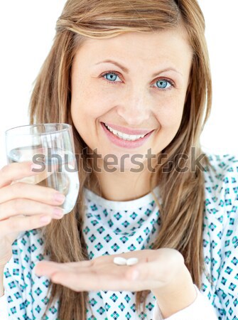 Stock photo: Smiling woman with medicine and a glass of water