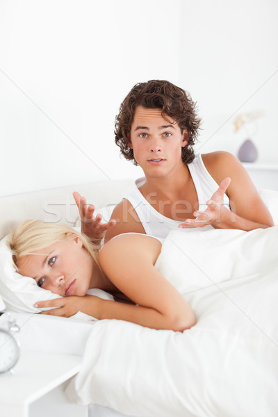 Portrait of an upset man arguing with his fiance in their bedroom Stock photo © wavebreak_media