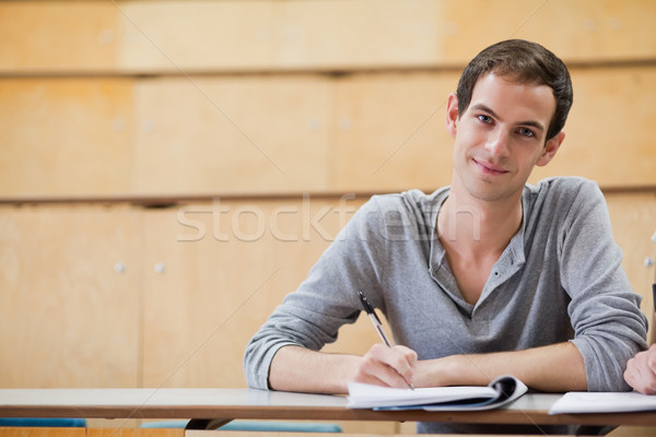Male student holding a pen in an amphitheater Stock photo © wavebreak_media