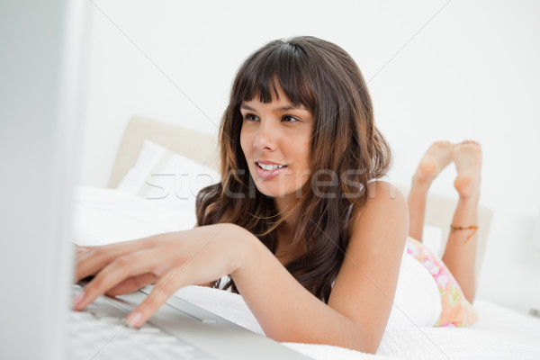 Mulher jovem laptop cama branco quarto Foto stock © wavebreak_media