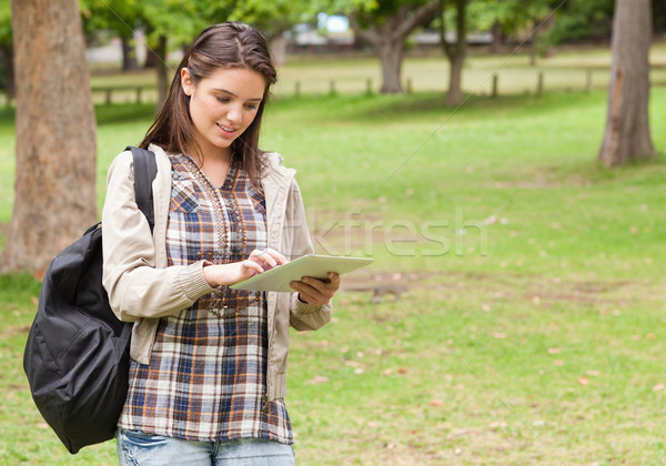 Young female student using a tactile tablet in a park Stock photo © wavebreak_media