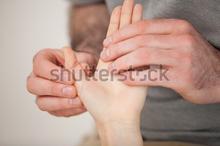 Thumb being massaged by a doctor in a room Stock photo © wavebreak_media