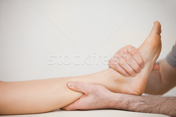 Muscle of a foot being massaged in a room Stock photo © wavebreak_media