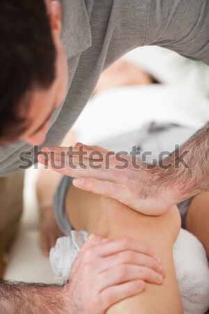 Woman lying on the belly while being massaged on his back in a room Stock photo © wavebreak_media