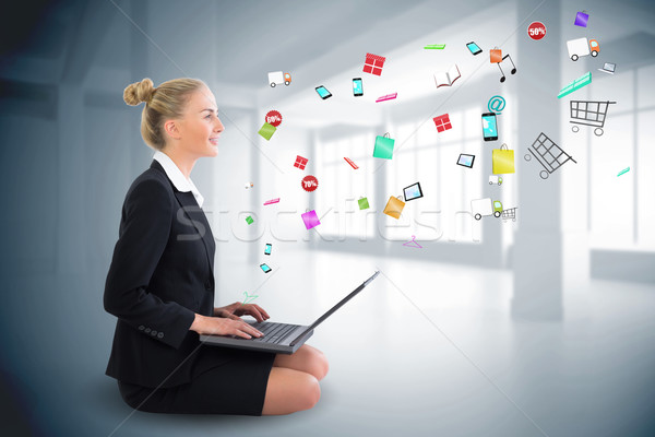 Mujer de negocios sesión usando la computadora portátil aplicación iconos Foto stock © wavebreak_media