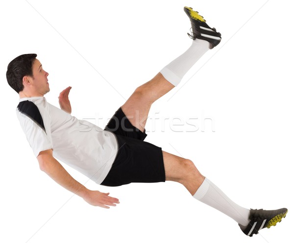 Stock photo: Football player in white kicking