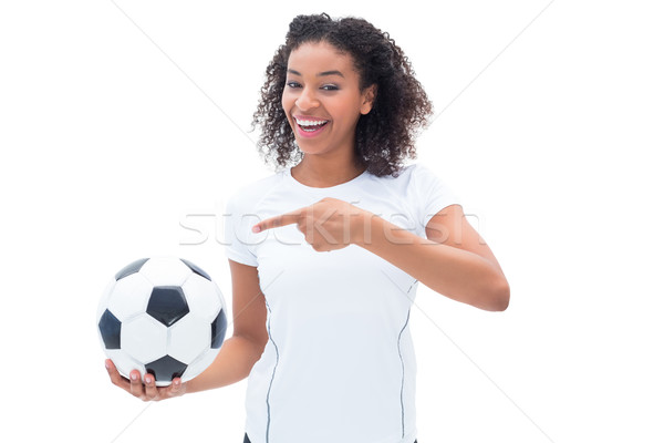 Stock photo: Pretty football fan in white holding ball and pointing to it