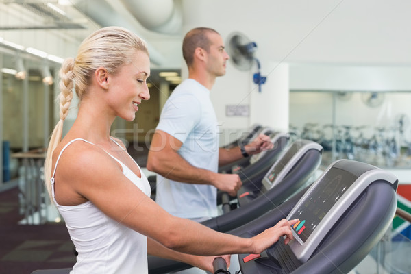 Side view mid section of couple running on treadmills at gym Stock photo © wavebreak_media