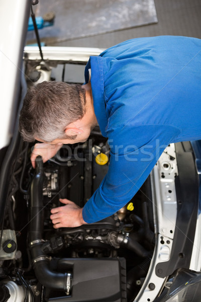 Mechanic examining under hood of car Stock photo © wavebreak_media