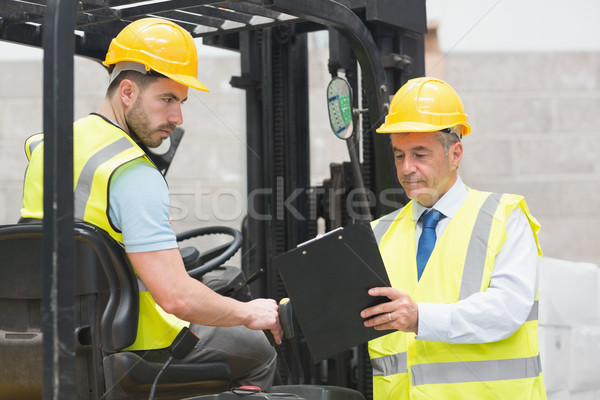 Forklift driver talking with his manager Stock photo © wavebreak_media