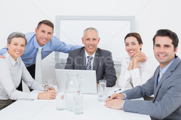 бизнес-команды рабочих счастливо вместе ноутбука служба Сток-фото © wavebreak_media