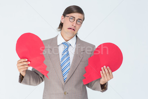 Geeky businessman crying and holding broken heart card Stock photo © wavebreak_media