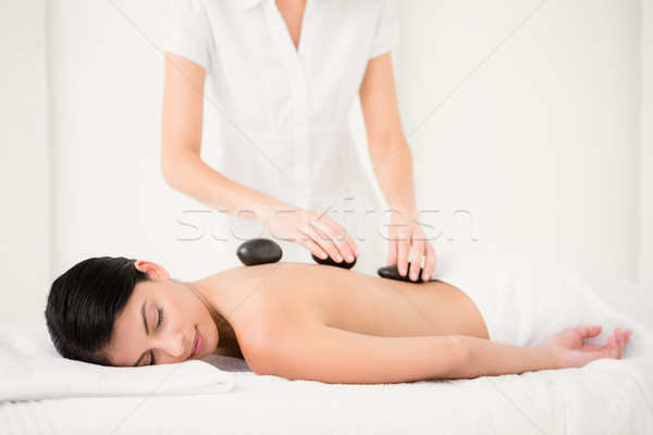 Pretty woman receiving a hot stone massage Stock photo © wavebreak_media