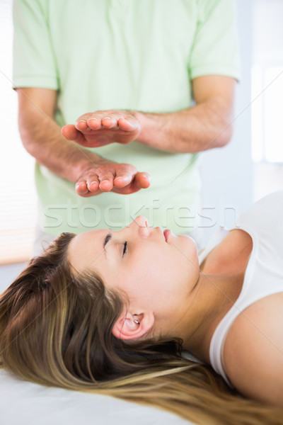 Stock photo: Relaxed pregnant woman getting reiki treatment